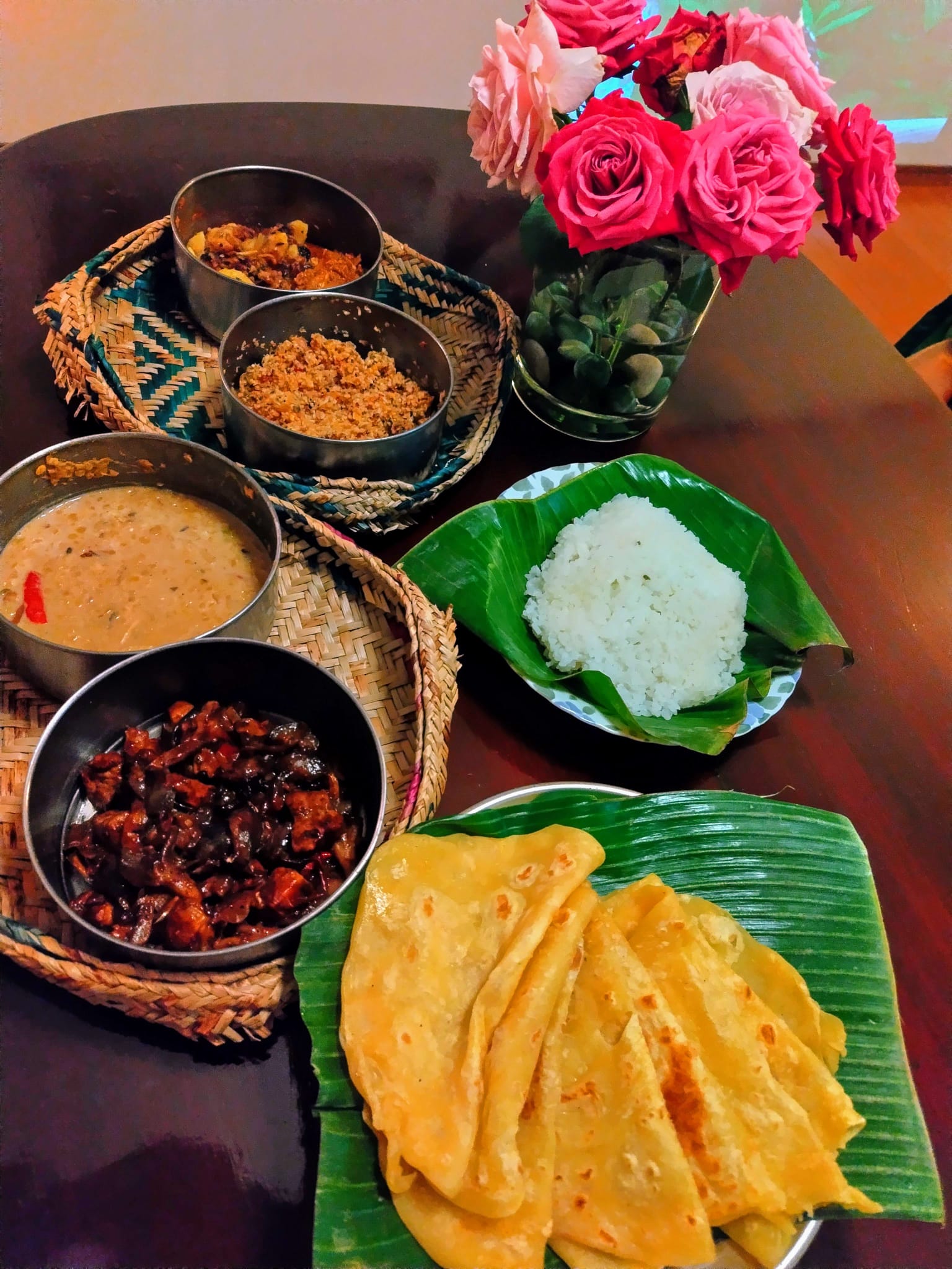 Rice, curries and roti on banana leaves